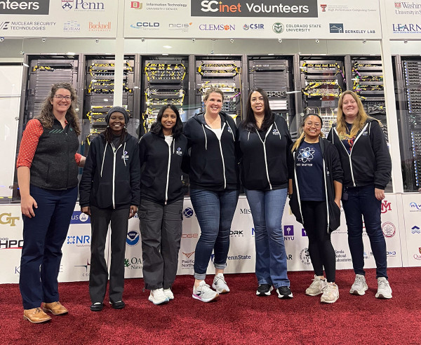 Seven women smiling in a row