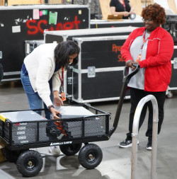 Person piling things into a cart 